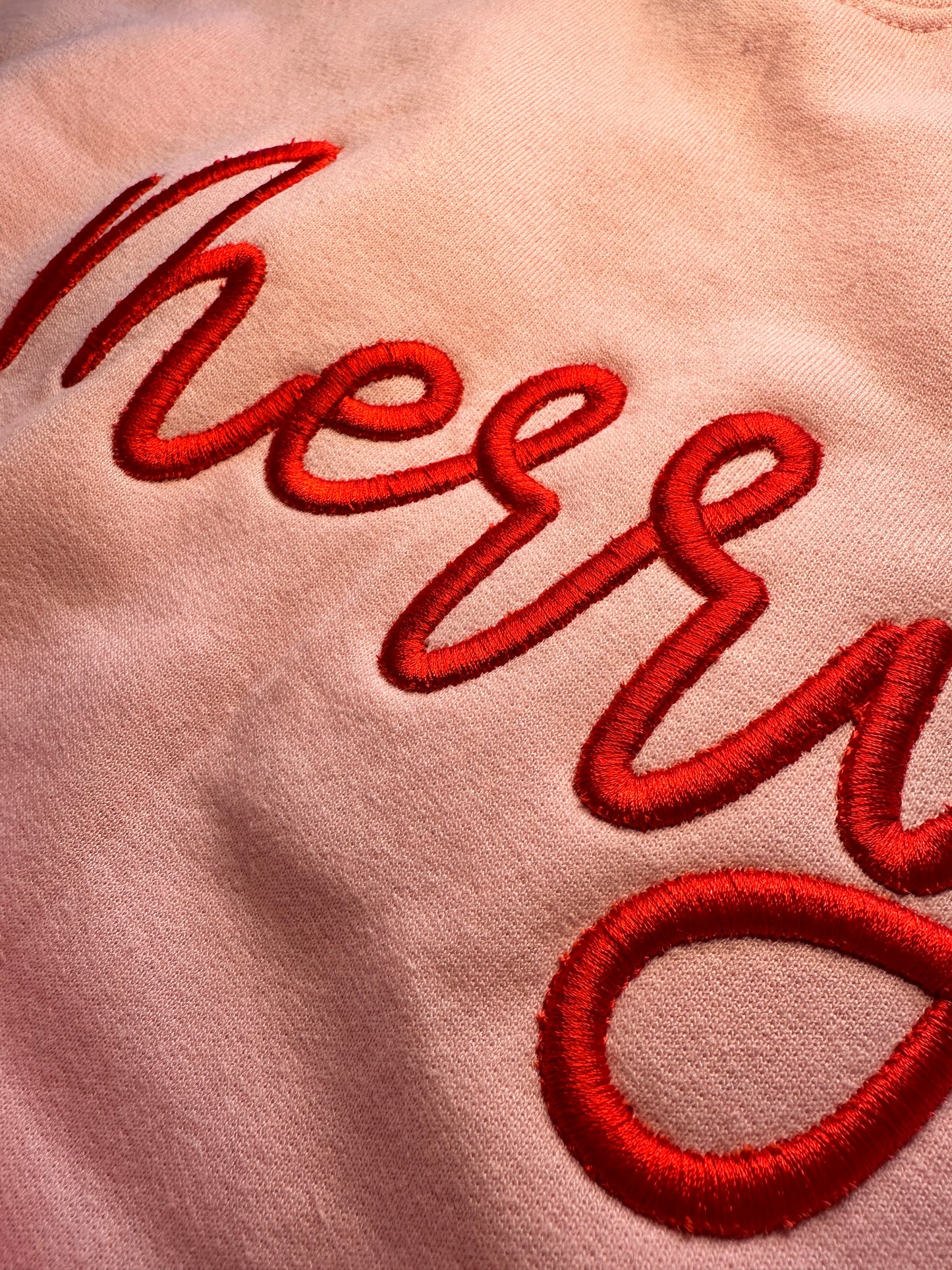 3D Puff Embroidered Merry in red on a pink sweatshirt