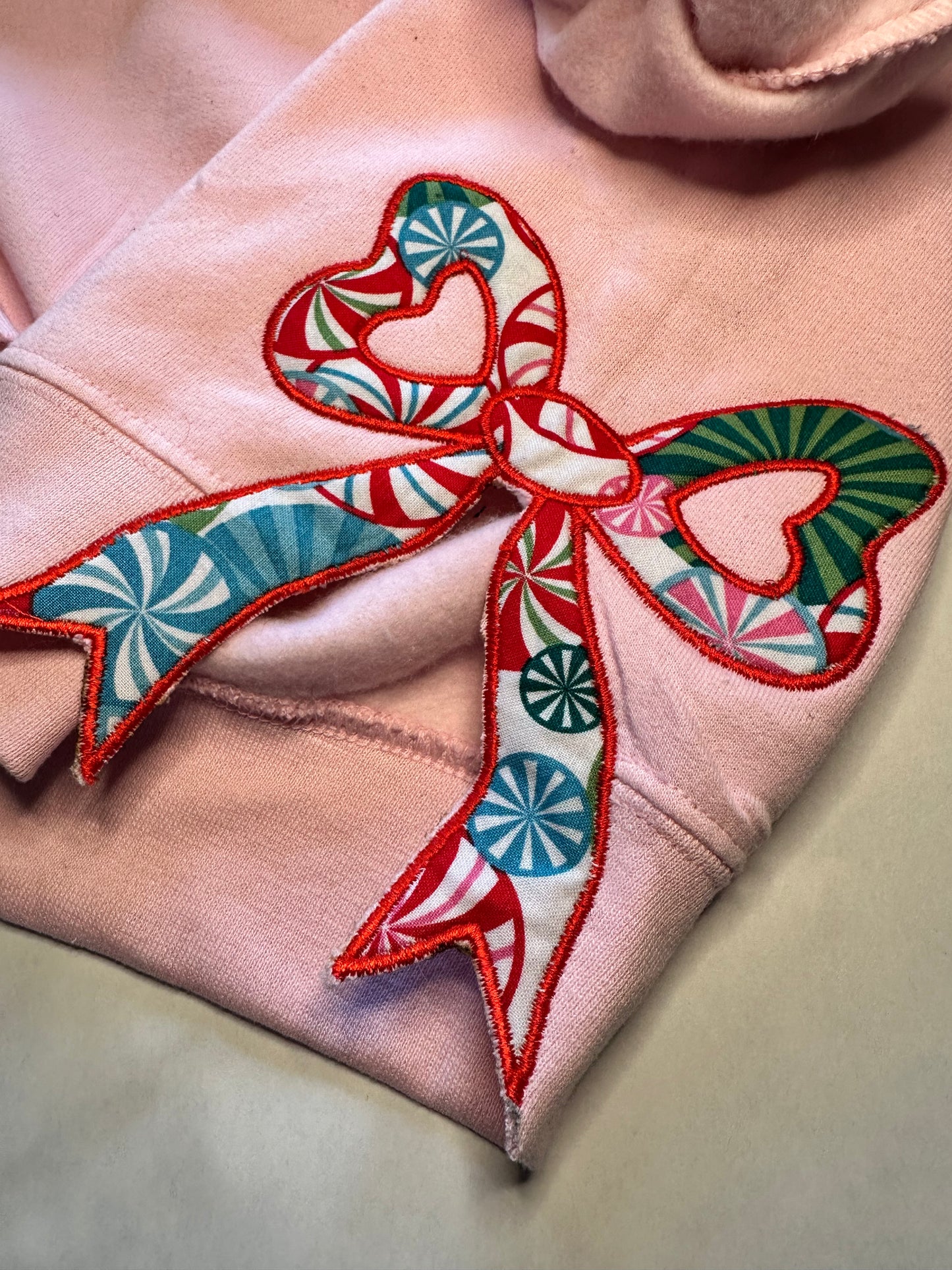Colorful candy fabric bow on pink sweatshirt