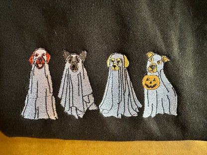 Four embroidered ghost designs on a black fabric background
