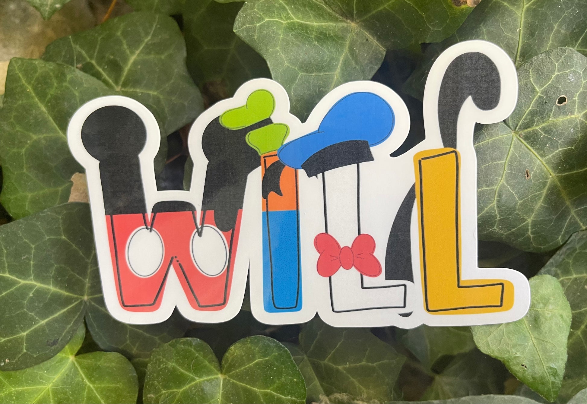 Close-up of personalized Disney stickers showing name customization and glossy waterproof vinyl finish