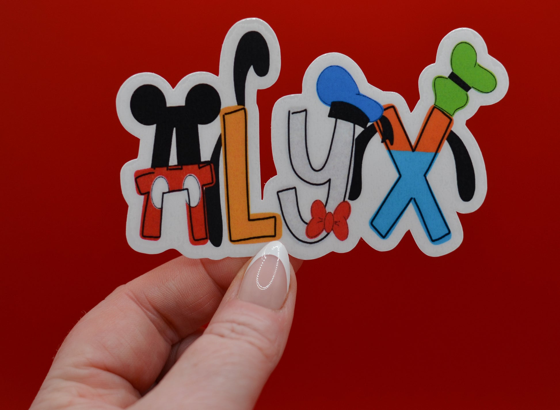 Close-up of personalized Disney stickers showing name customization and glossy waterproof vinyl finish.